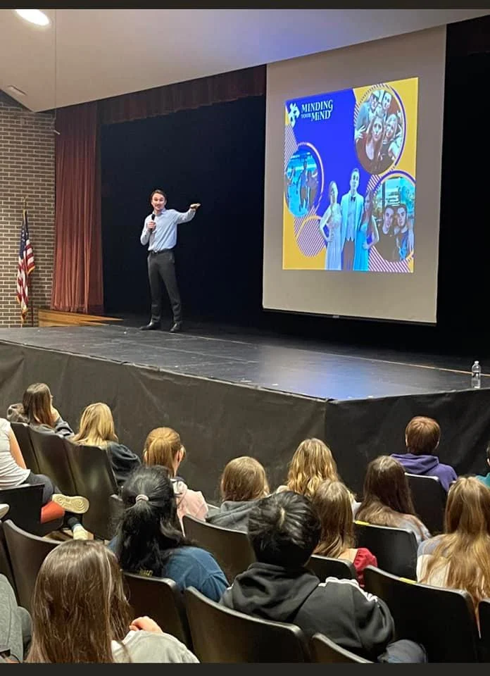 Evan presenting to students in a smaller auditorium
