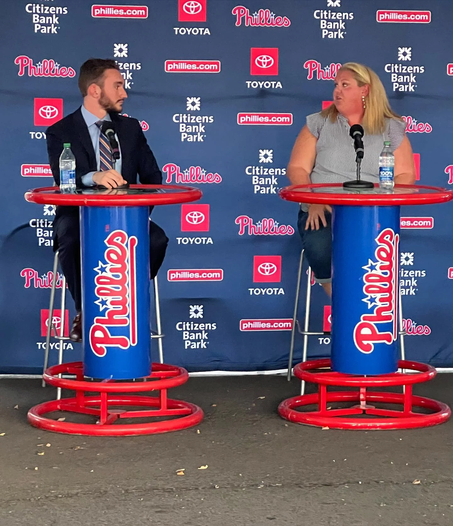 Evan participating in an interview at a table with a microphone