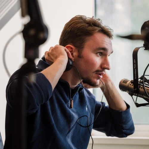 Evan Transue at a podcast microphone